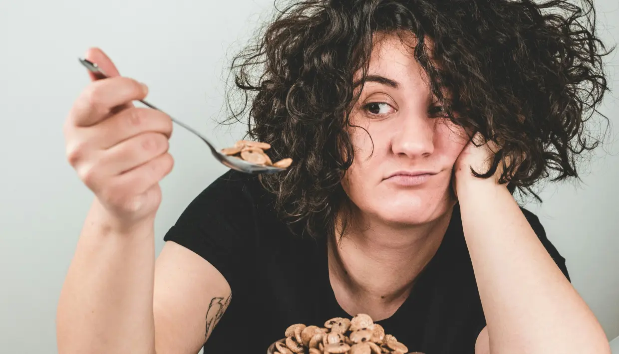 woman disinterest in eating cereal