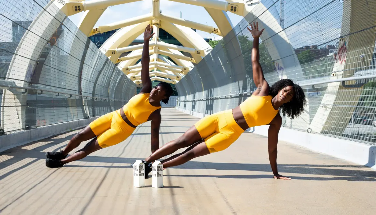 two black women working out on a walkway