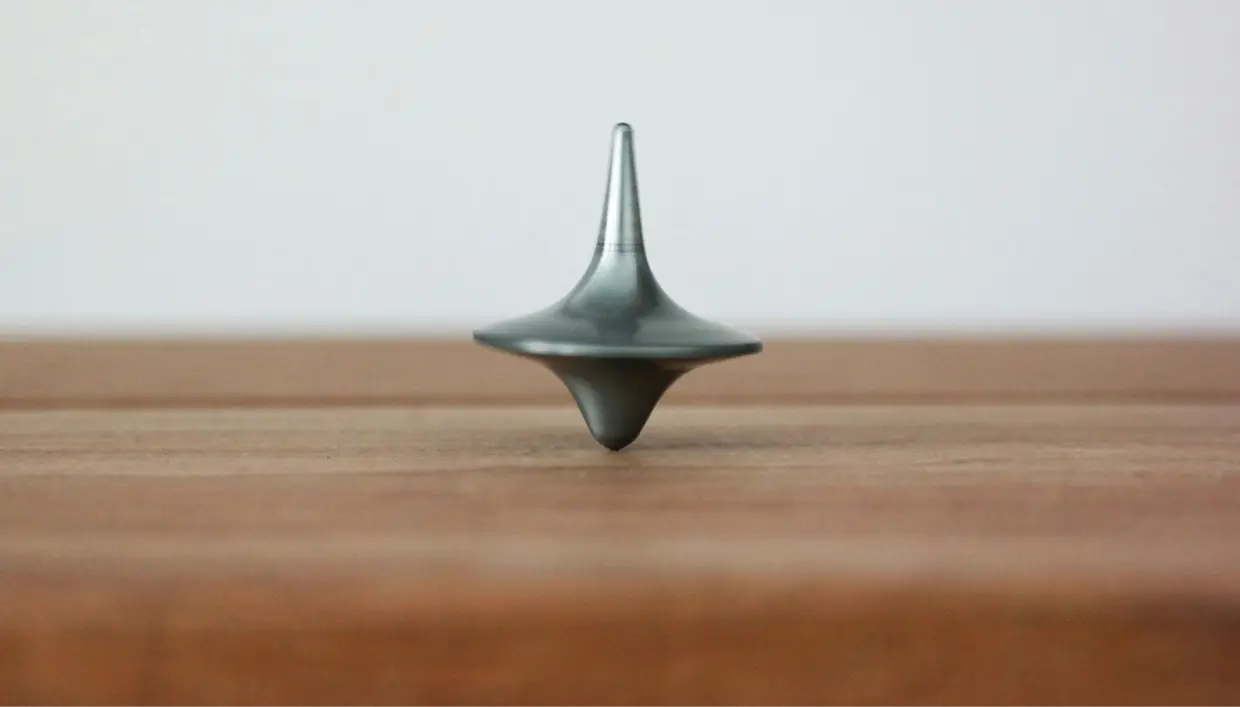 top spinning on a wooden table