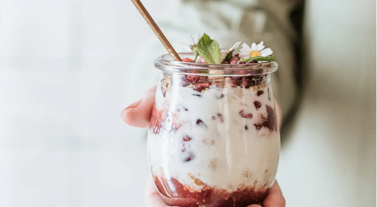 hand holding a jar of yogurt